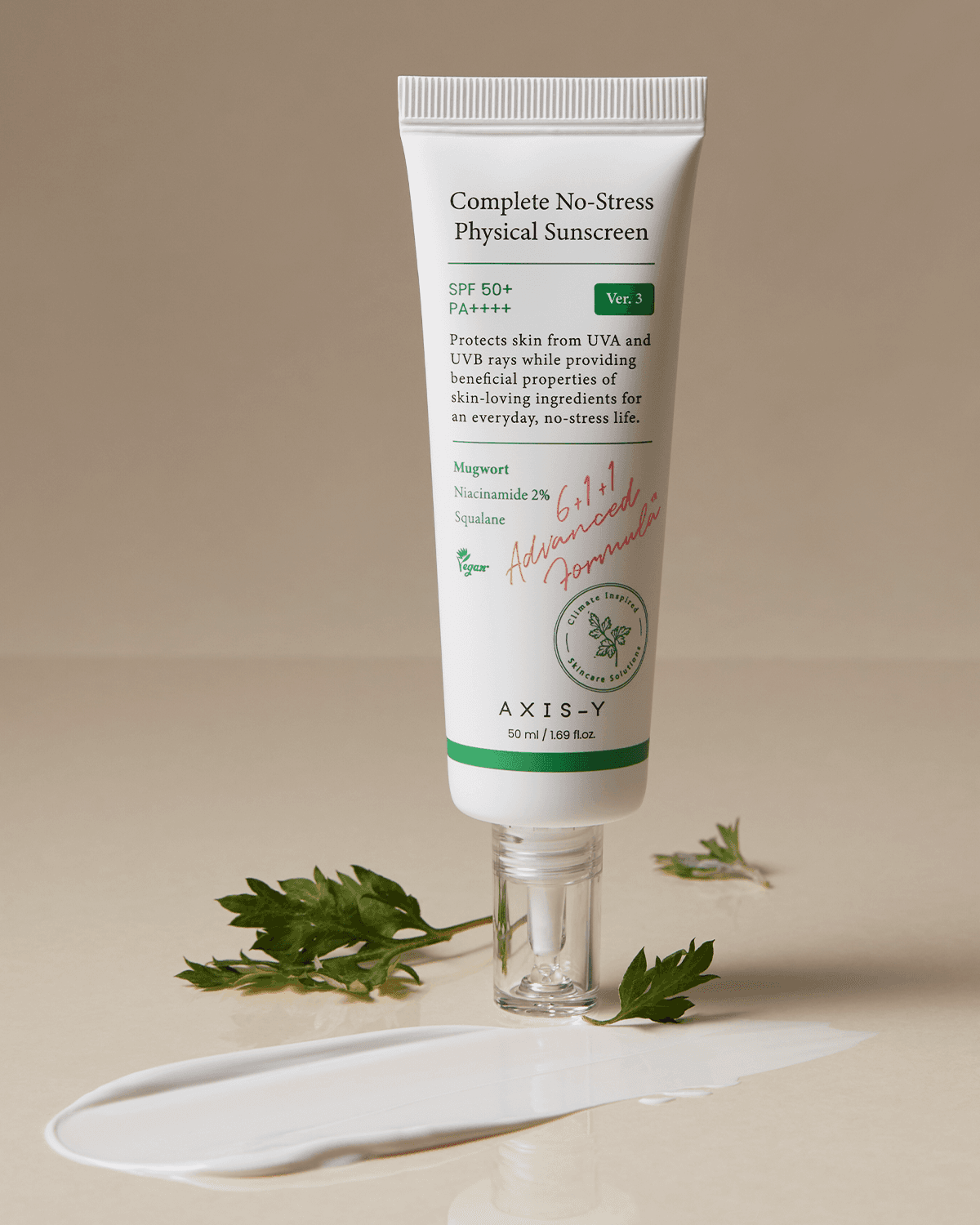 OTC version Complete No-Stress Physical Sunscreen V.3 with Mugwort and Niacinamide, displayed with a swatch of the product and fresh green leaves for a natural touch.