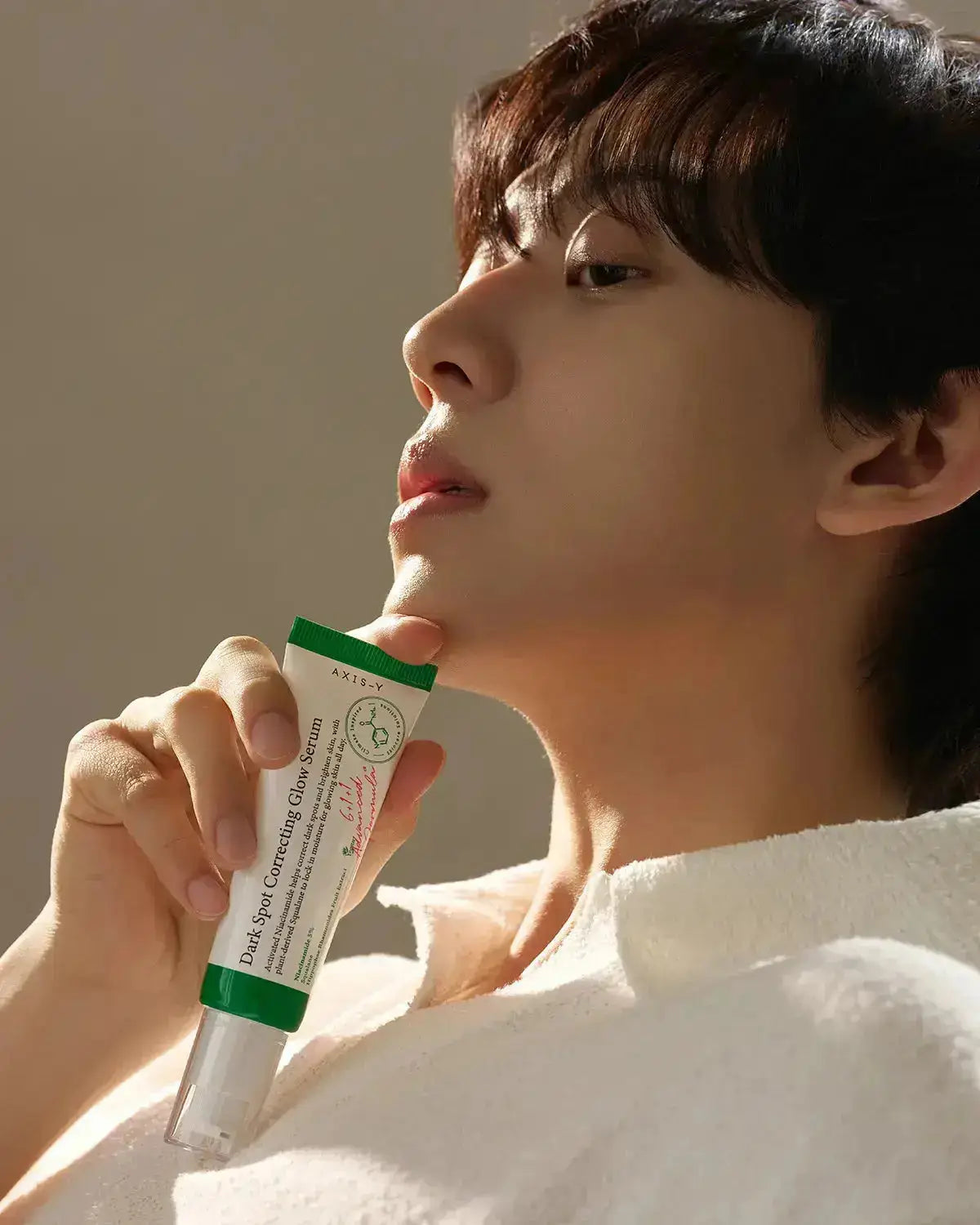 Person holding Dark Spot Correcting Glow Serum, highlighting its brightening and hydrating benefits for a radiant complexion.