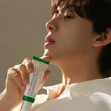 Person holding the Dark Spot Correcting Glow Serum, showcasing its lightweight texture and brightening benefits for radiant, even-toned skin.