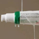 Close-up of Dark Spot Correcting Glow Serum with niacinamide and squalane, dripping to highlight its hydrating and brightening formula.