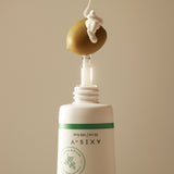 Dark Spot Correcting Glow Serum with niacinamide and squalane, artistically dispensed over an olive, symbolizing hydration and nourishment.