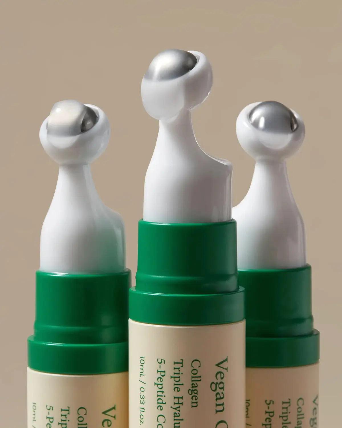 Close-up of Vegan Collagen Eye Serum applicators, featuring a cooling metal tip for precise and soothing application around the eyes.