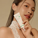 Person holding Complete No-Stress Physical Sunscreen, highlighting its lightweight, protective formula for a radiant and healthy complexion.